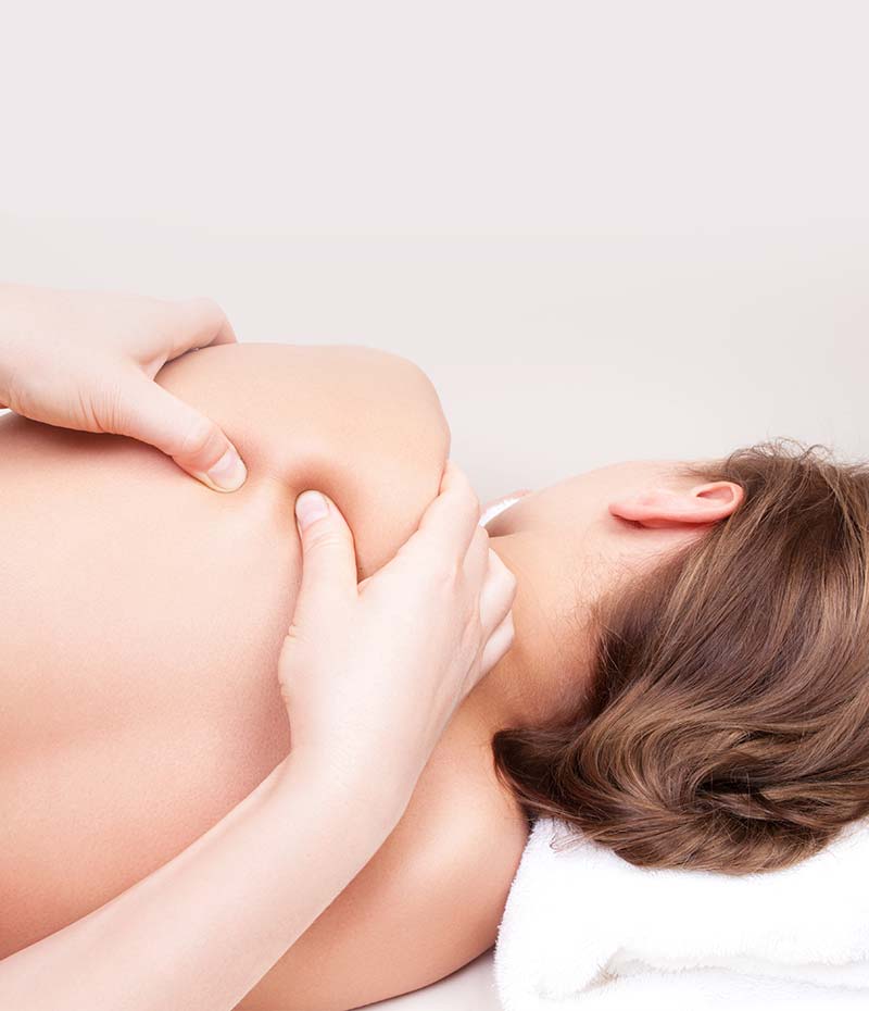 Therapist performing a deep tissue massage in Sydney, focusing on shoulder muscle tension relief.