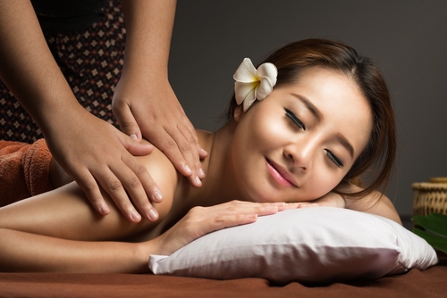 Woman enjoying a professional wellness massage session Woman enjoying a professional wellness massage session